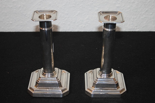 Appraisal: A PAIR OF SILVER CANDLESTICKS with plain columns and square