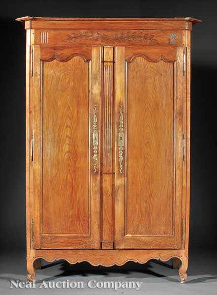 Appraisal: A French Provincial Carved Oak Armoire cornice with canted corners