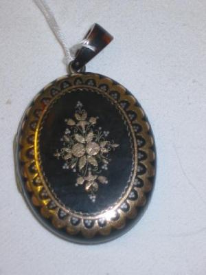 Appraisal: A VICTORIAN TORTOISESHELL LOCKET of oval form inset with gold