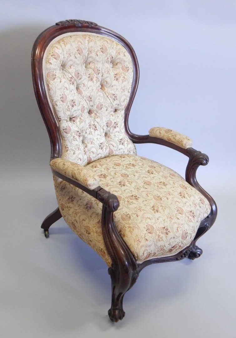 Appraisal: A Victorian mahogany show frame open armchair with a button