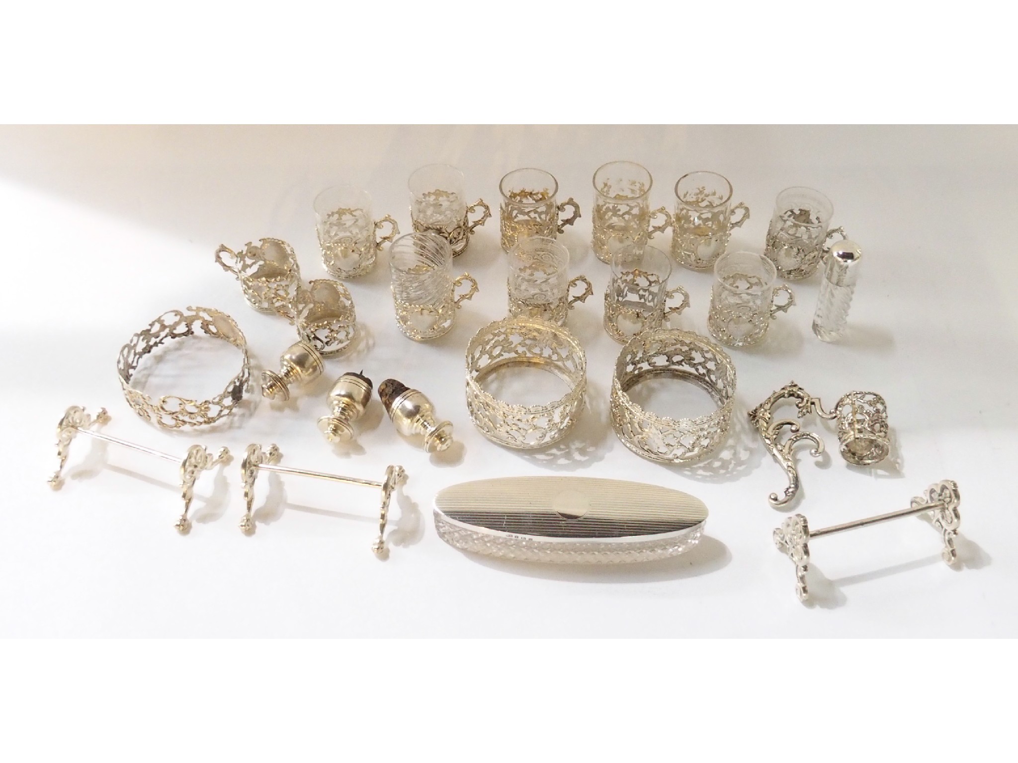 Appraisal: A lot comprising a set of white metal glass holders