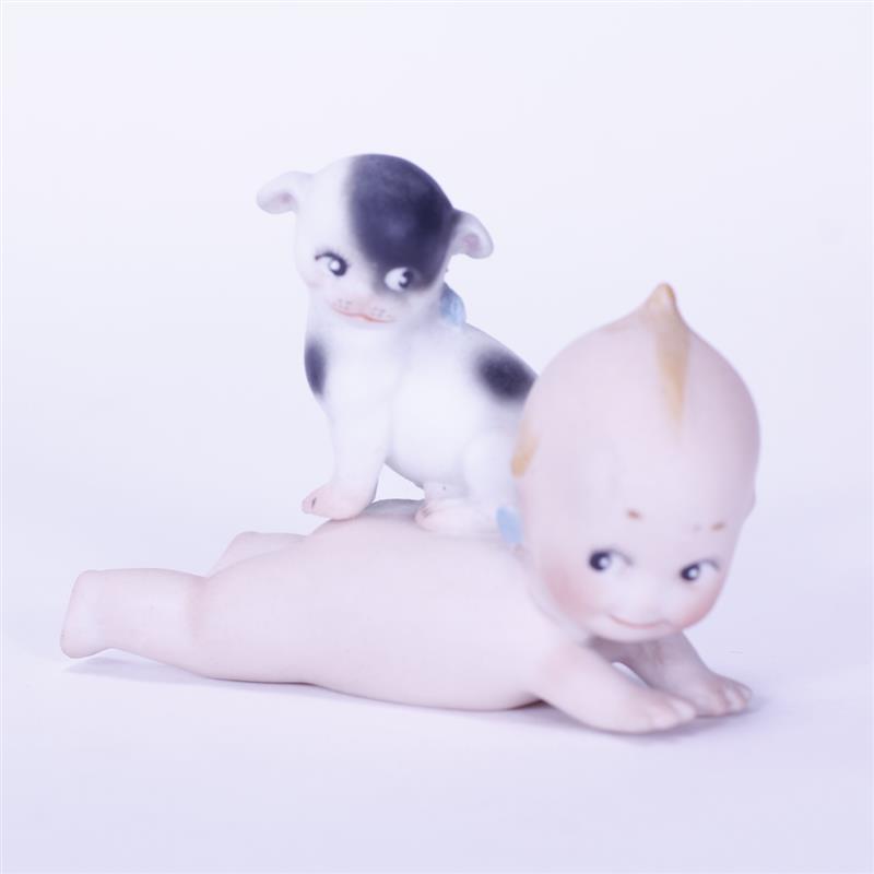 Appraisal: German Bisque action Kewpie Doll laying down with Doodle Dog