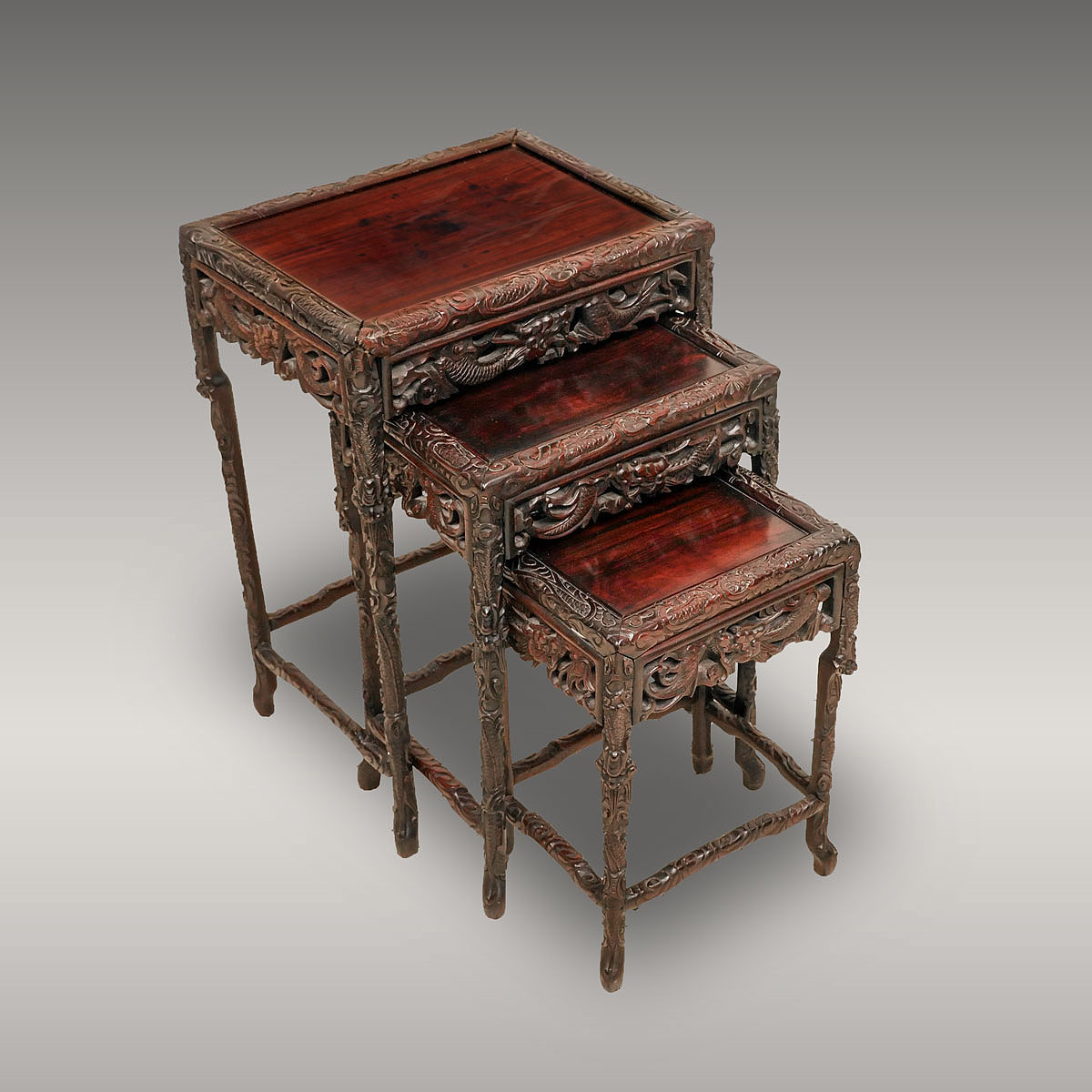 Appraisal: EXQUISITELY CARVED CHINESE NESTING TABLES intricately carved Chinese nesting tables