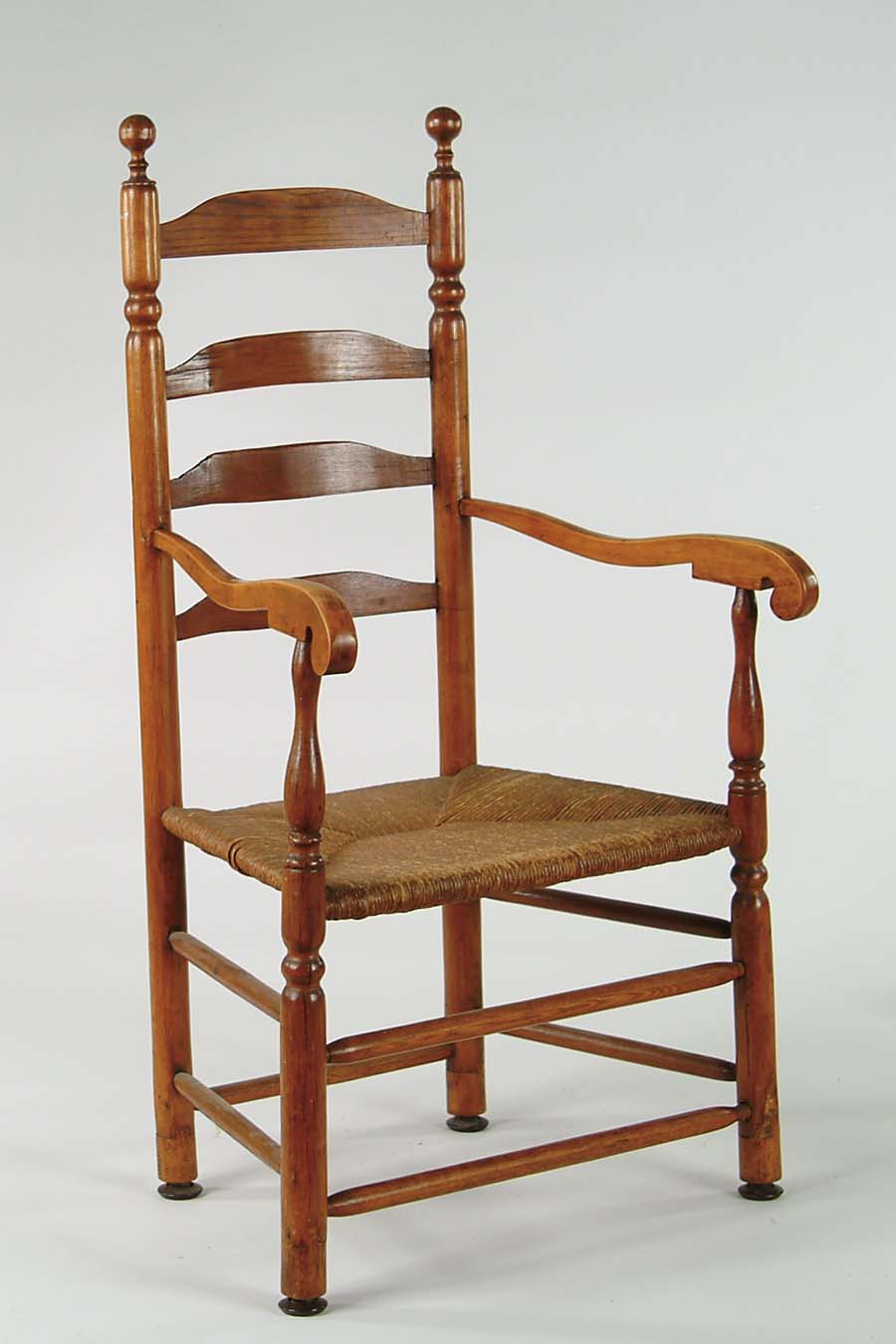 Appraisal: EARLY LADDERBACK ARMCHAIR th Century Four shaped horizontal slats turned