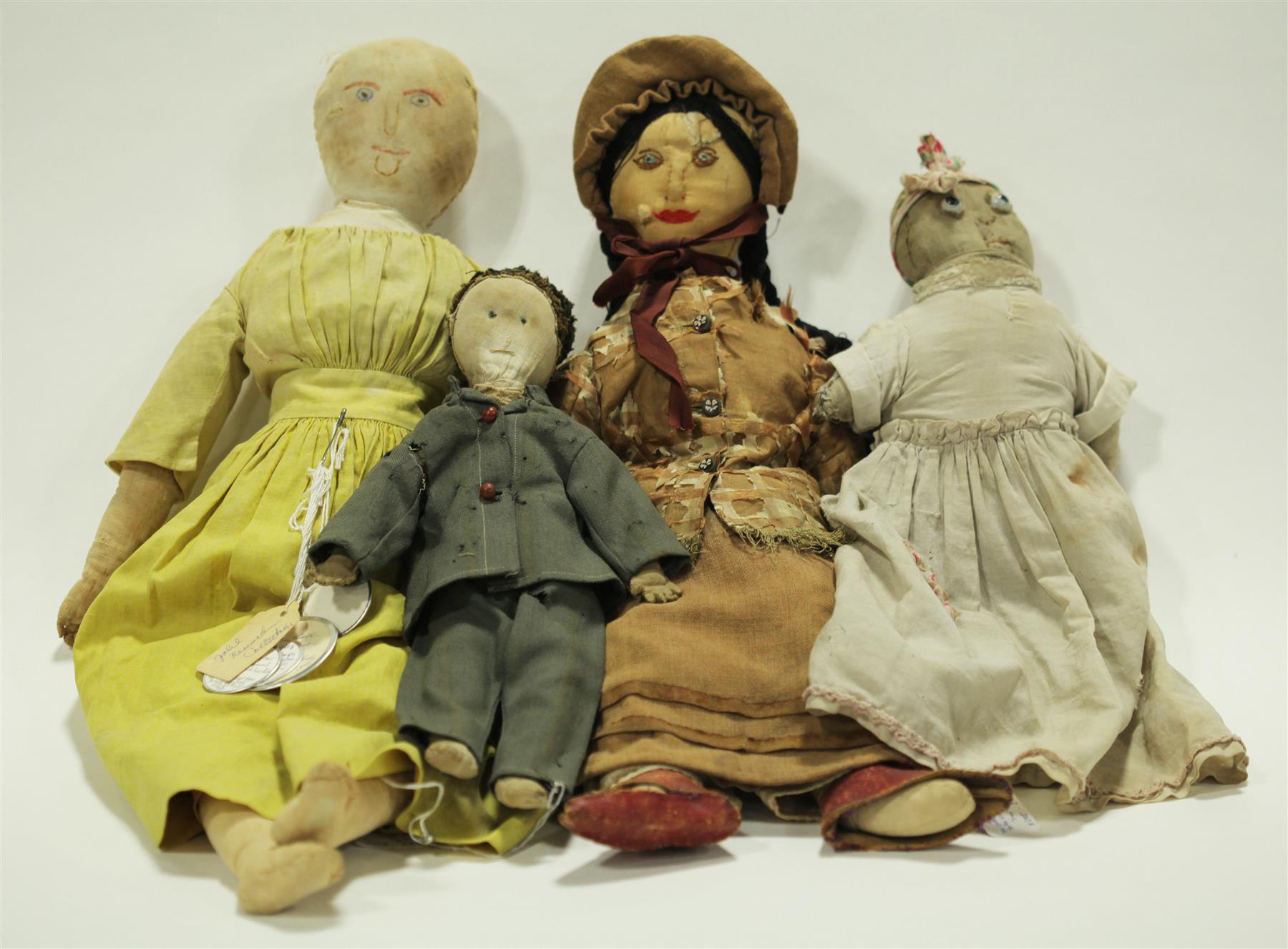 Appraisal: FOUR CLOTH DOLLS WITH STITCHED AND DRAWN FEATURES American three