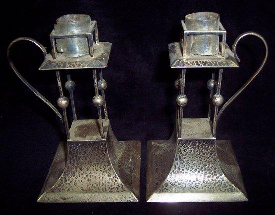 Appraisal: A pair of Arts and Crafts style candlesticks of hammered