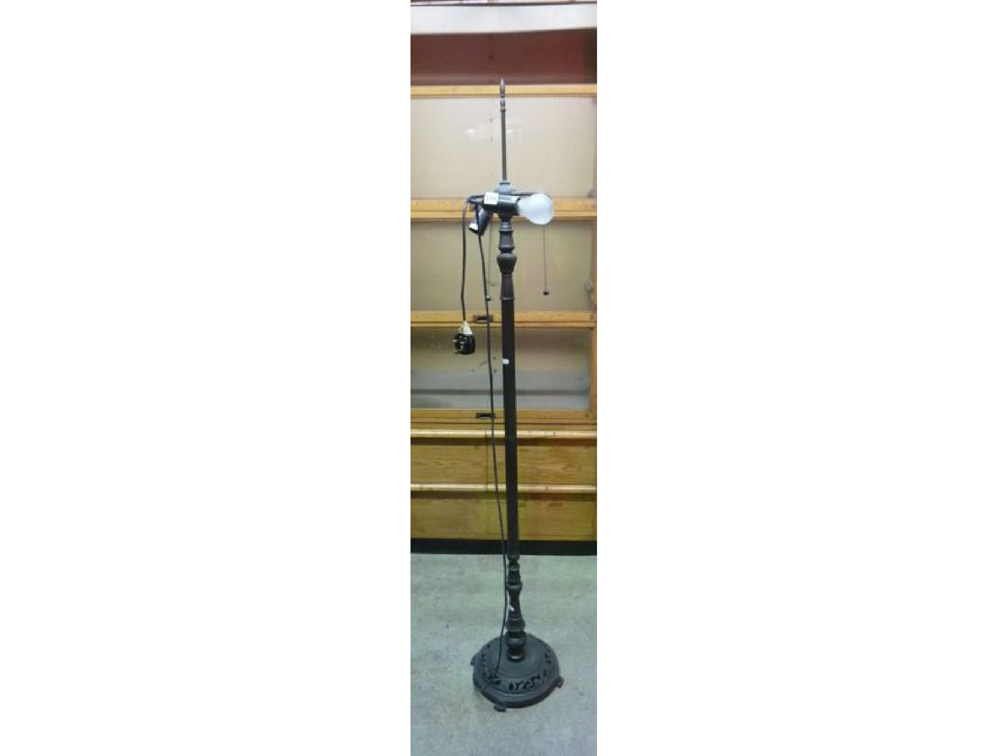 Appraisal: A contemporary cast metal two branch standard lamp with partially