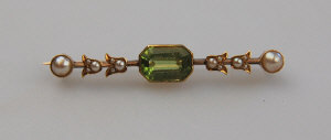 Appraisal: Rectangular peridot and pearl set bar brooch on knife-edge bar