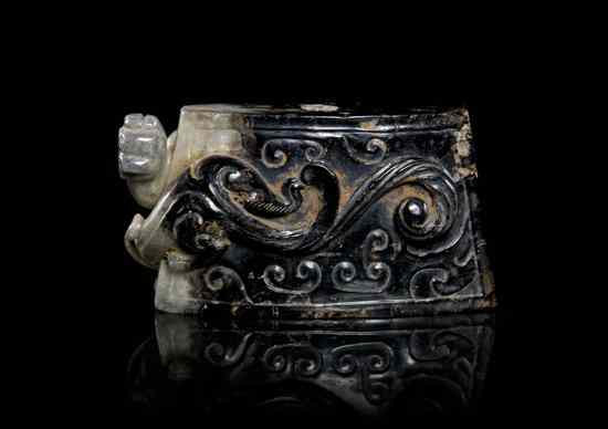 Appraisal: A Chinese Jade Sword Pommel of inky black white and