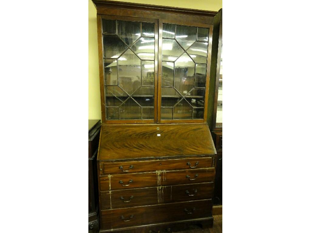 Appraisal: A Georgian mahogany estate bureau bookcase the flame veneered fall