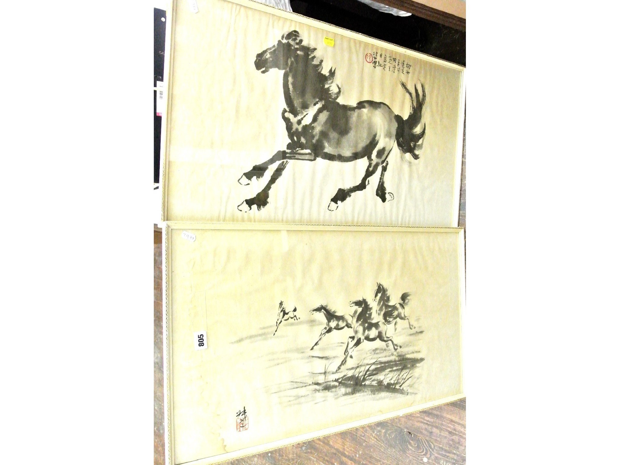 Appraisal: A pair of oriental monochrome prints of running horses both