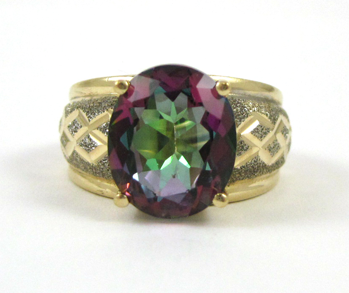 Appraisal: MYSTIC TOPAZ AND FOURTEEN KARAT GOLD RING centering an oval-cut