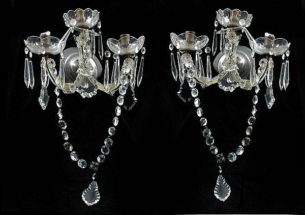 Appraisal: A pair of cut glass three light wall sconces height