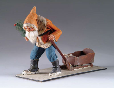 Appraisal: SANTA TRUDGER WITH SLED A Santa stooped over and dragging