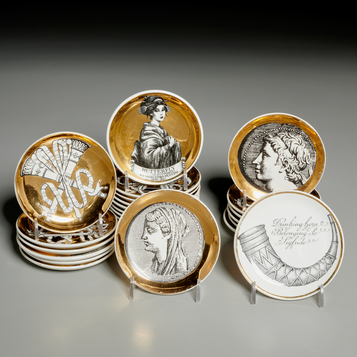 Appraisal: PIERO FORNASETTI ASSORTED COASTERS c Italy gilt and transfer decoration