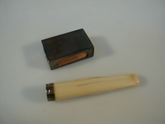 Appraisal: An ivory cigar holder with silver band and silver matchbox