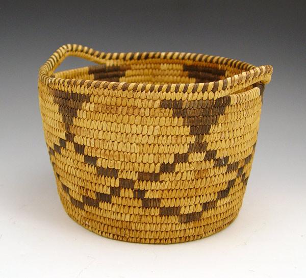 Appraisal: SOUTHWEST APACHE HANDLED COILED BASKET Geometric pattern basket with handles