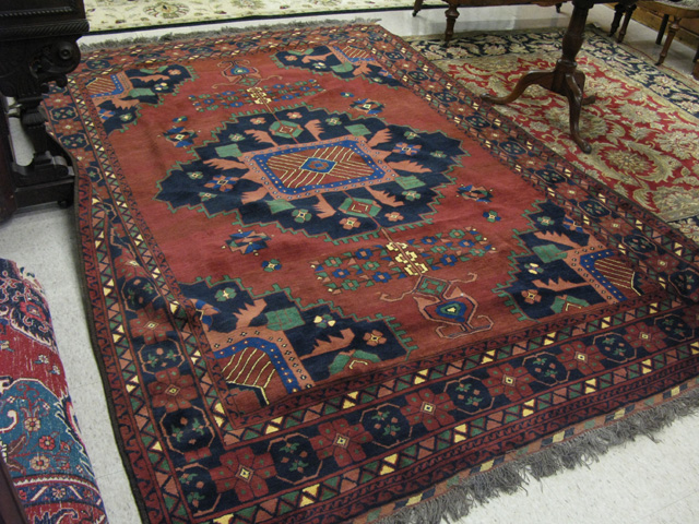 Appraisal: AFGHANI TRIBAL CARPET central geometric medallion and quarter-medallion design on