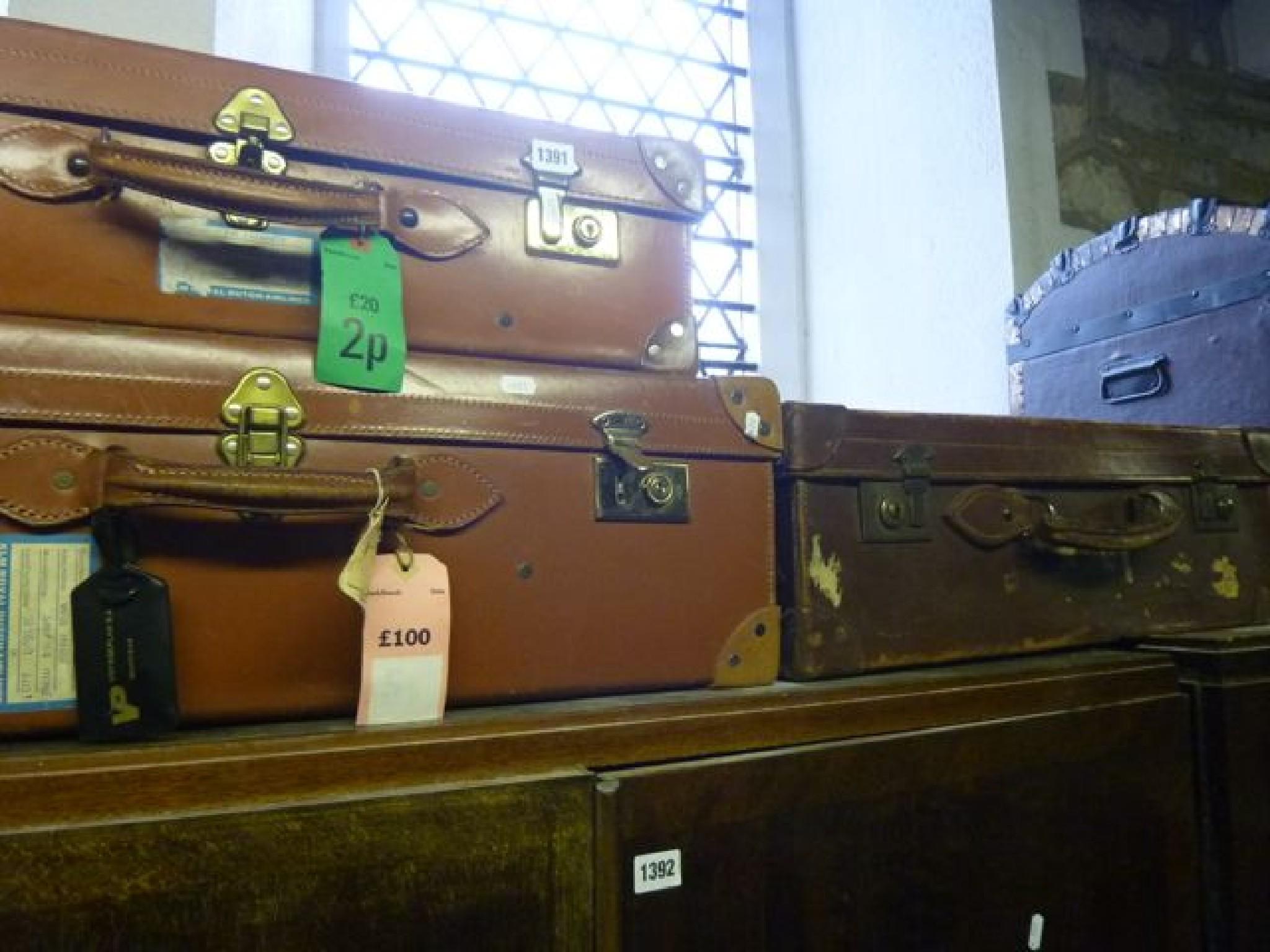 Appraisal: Three vintage leather suitcases with brass locks and reinforced corners