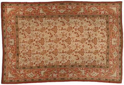 Appraisal: Oushak rug repeating red and beige design on lighter field