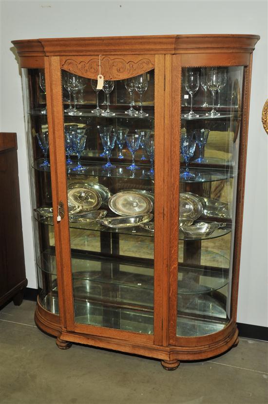 Appraisal: CHINA CABINET Oak having a large glazed door curved glass