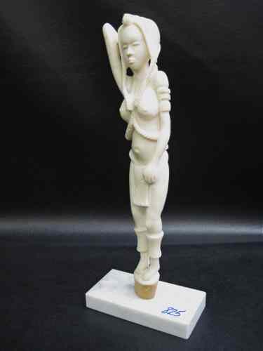 Appraisal: AN AFRICAN IVORY CARVED FIGURE of woman wearing very long