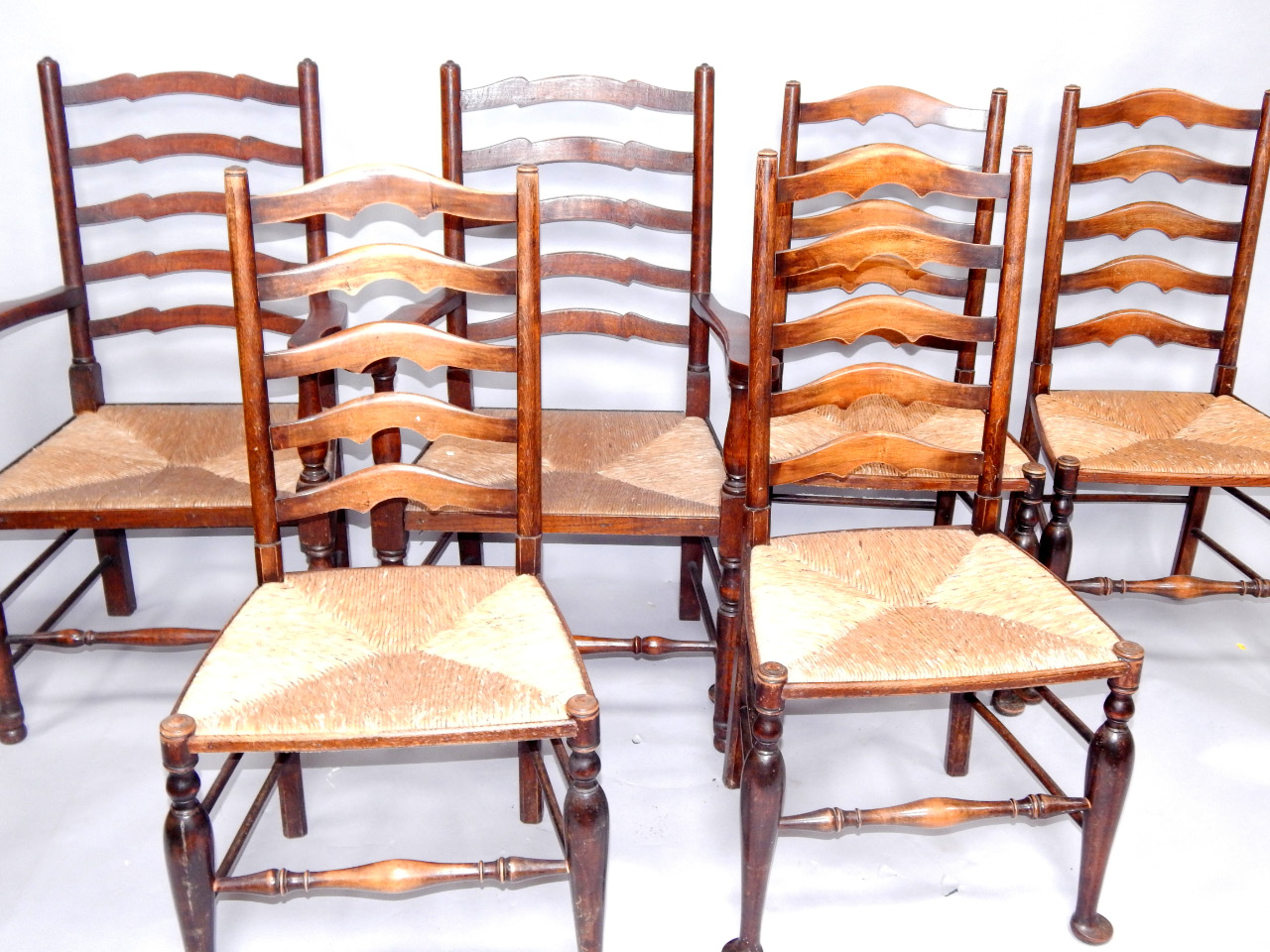 Appraisal: A harlequin set of six oak ladder back dining chairs