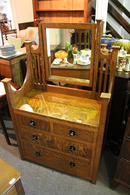 Appraisal: AN ARTS AND CRAFTS DRESSING CHEST with swing mirror fitted