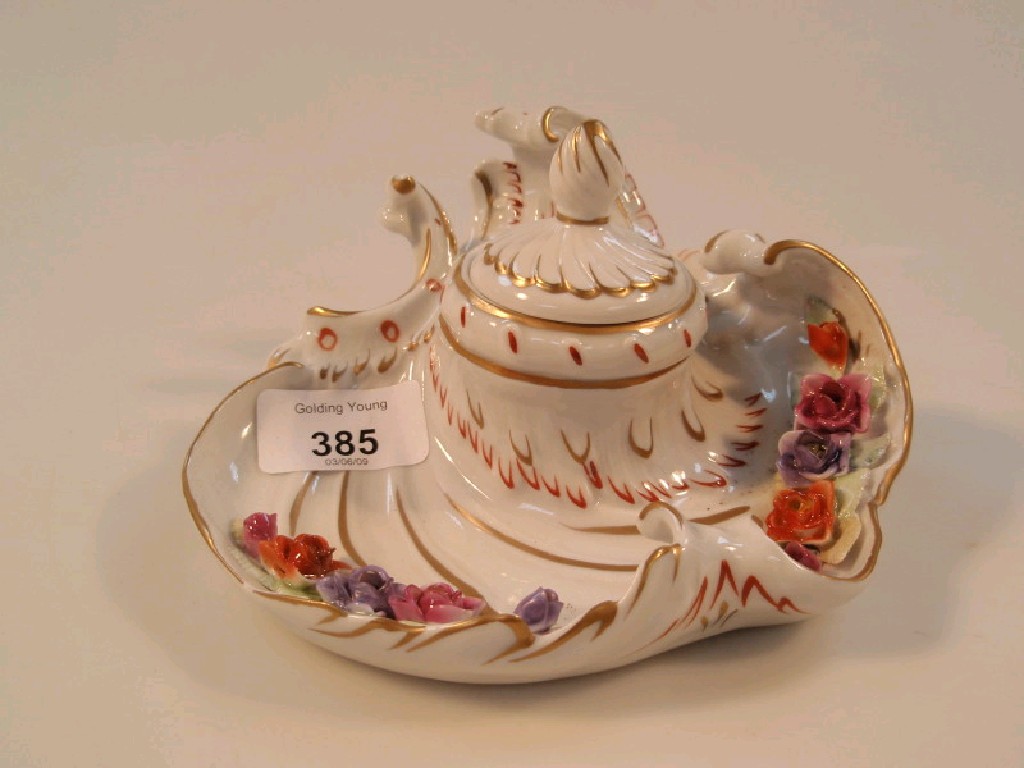 Appraisal: A German porcelain ink well of rococo scroll design encrusted