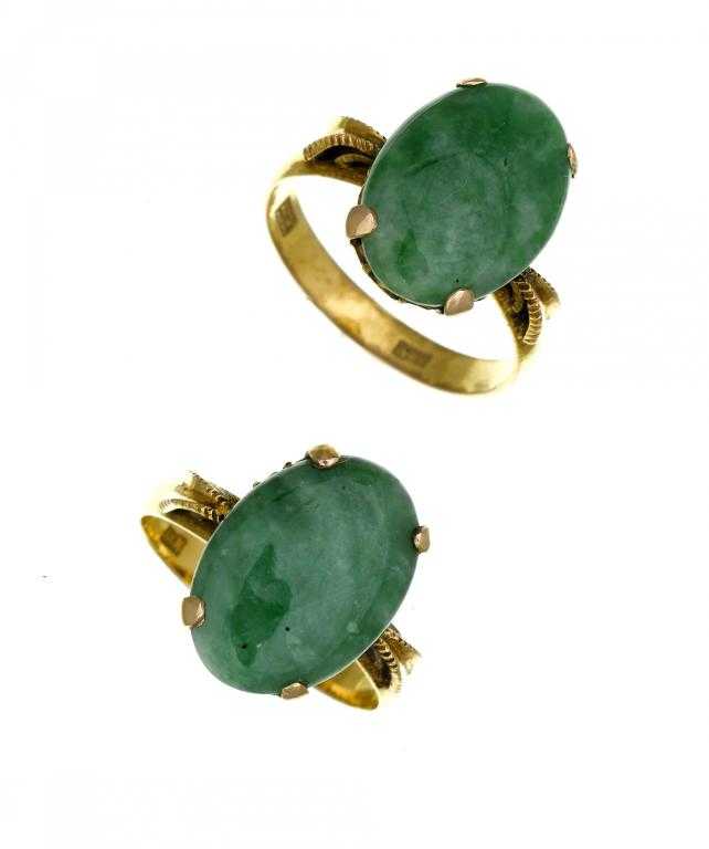 Appraisal: TWO JADEITE RINGS the vivid mottled green cabochon similarly set