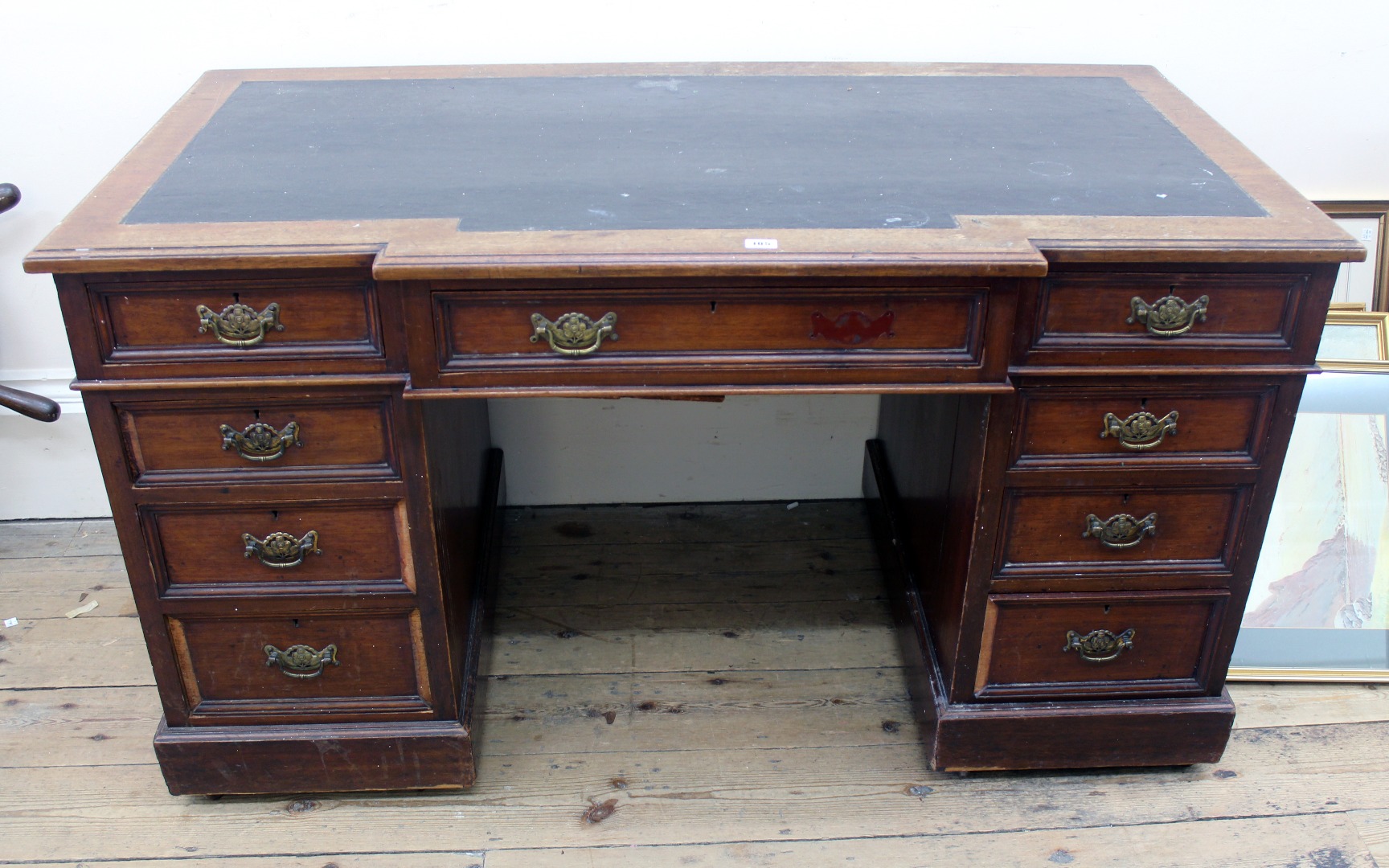 Appraisal: An Edwardian walnut kneehole desk with breakfront inset top and