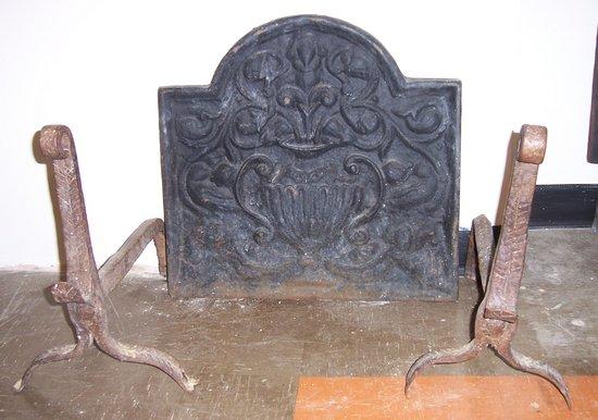 Appraisal: A cast iron fire back with arched top cast with