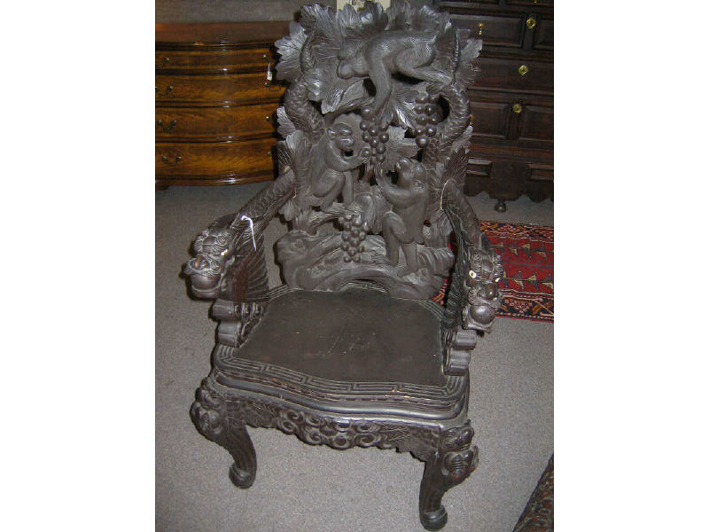 Appraisal: ASIAN CARVED WOODEN ARMCHAIR Finely detailed allover the back showing