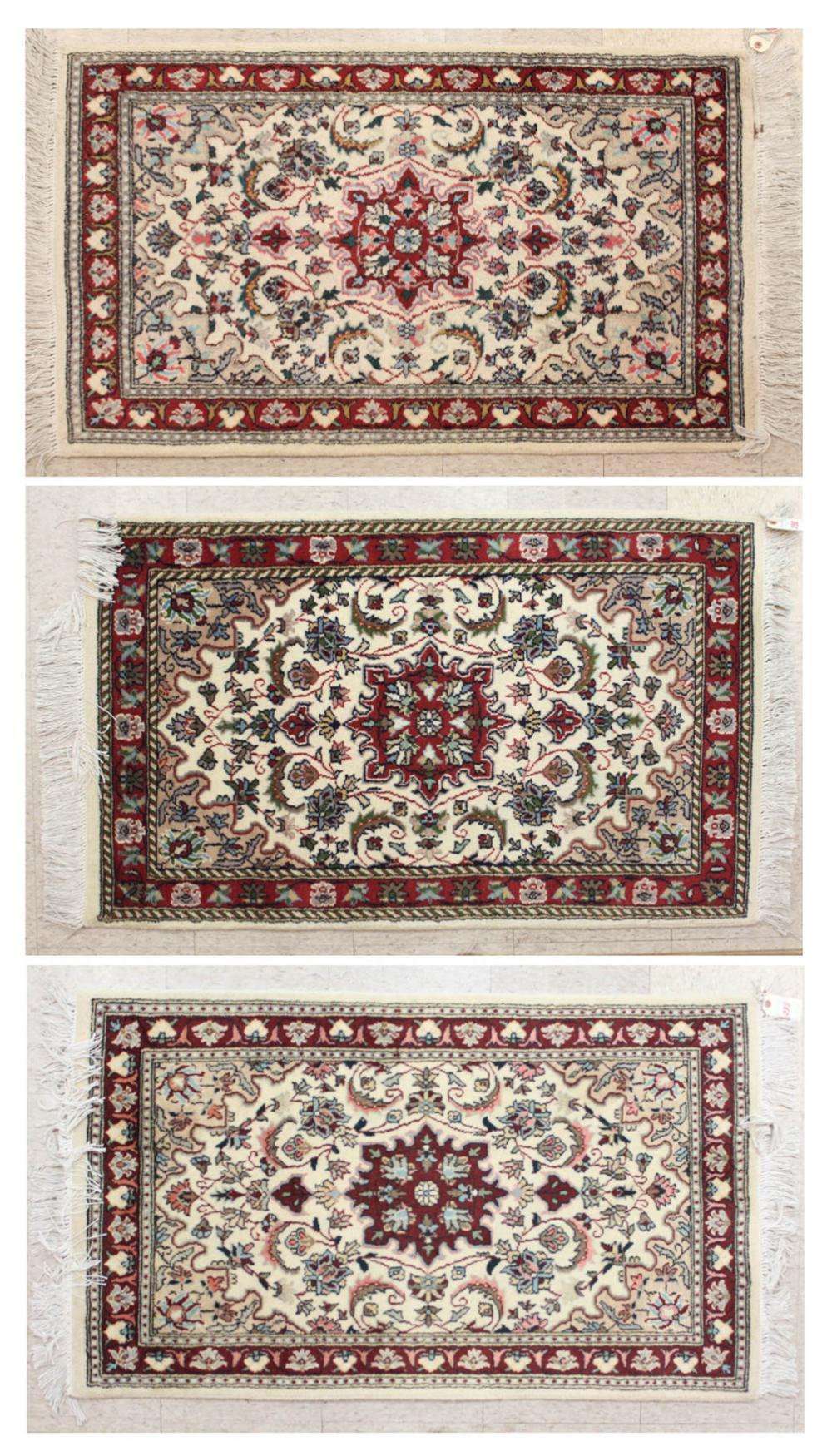 Appraisal: THREE SIMILAR HAND KNOTTED ORIENTAL AREA RUGS Indo-Persians floral and