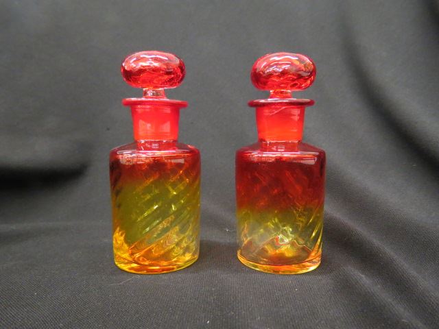 Appraisal: Pair of Amberina Art Glass Cologne Bottles swirl design tall