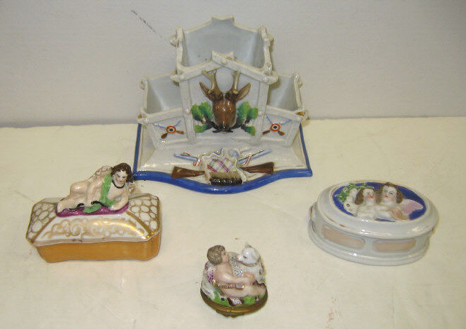 Appraisal: FOUR VICTORIAN PORCELAIN BOXES Comprising three-sectional trophy stand with relief