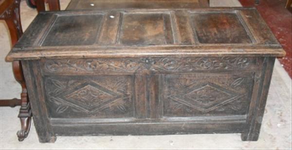 Appraisal: A panelled oak coffer with carved decoration