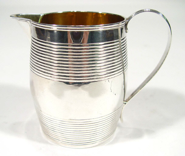 Appraisal: Georgian silver cream jug with banded decoration and gilt interior