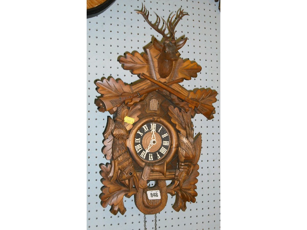 Appraisal: Contemporary Black Forest cuckoo clock the black dial within a