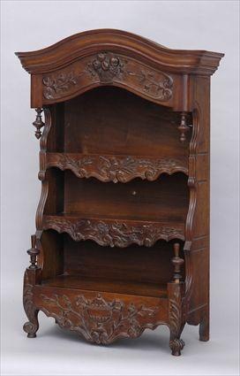 Appraisal: BRITTANY PROVINCIAL CARVED WALNUT TABLE CABINET The serpentine molded overhang