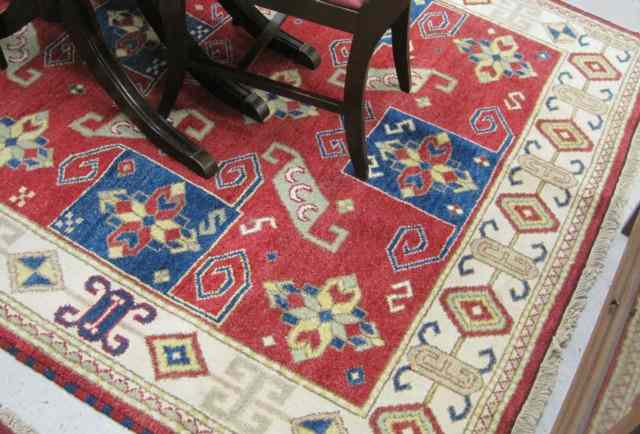 Appraisal: HAND KNOTTED ORIENTAL CARPET Indo-Kazak overall geometric design on red