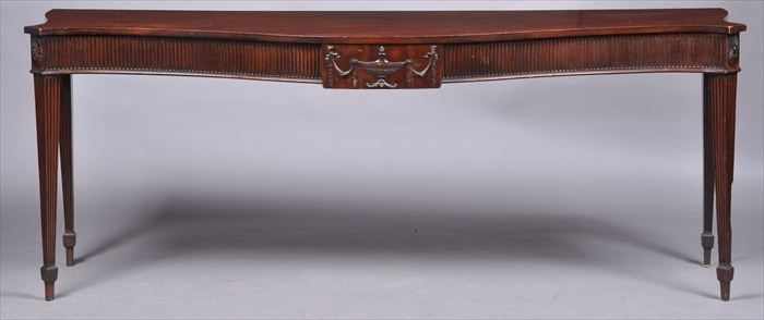 Appraisal: GEORGE III CARVED MAHOGANY SERPENTINE-FRONTED SERVING TABLE The plain top