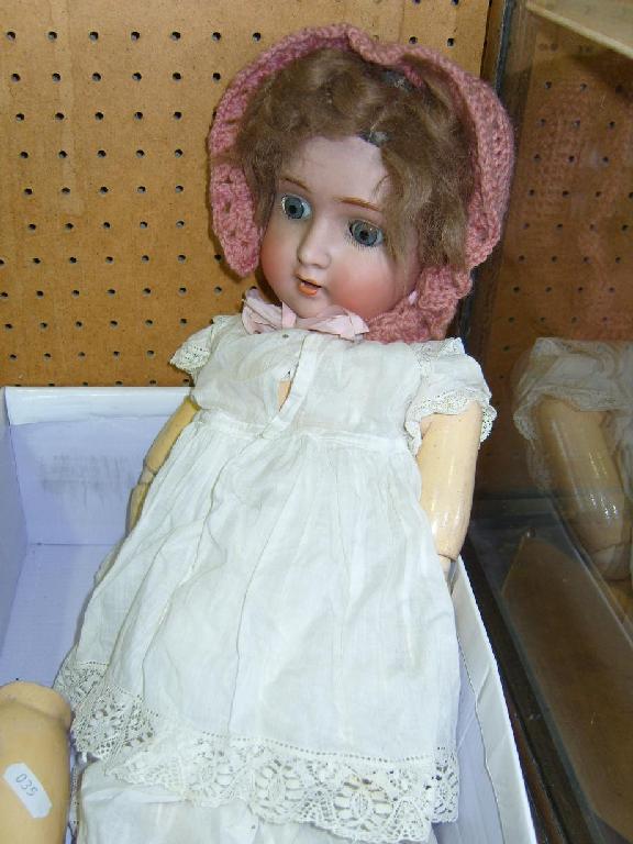 Appraisal: A German bisque headed doll with closing blue eyes and