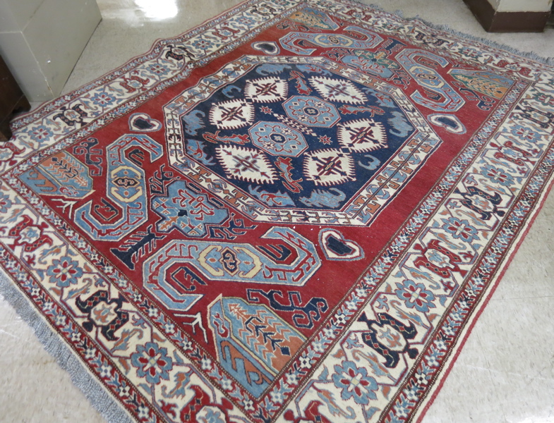 Appraisal: HAND KNOTTED ORIENTAL AREA RUG Pakistani Caucasian geometric central medallion