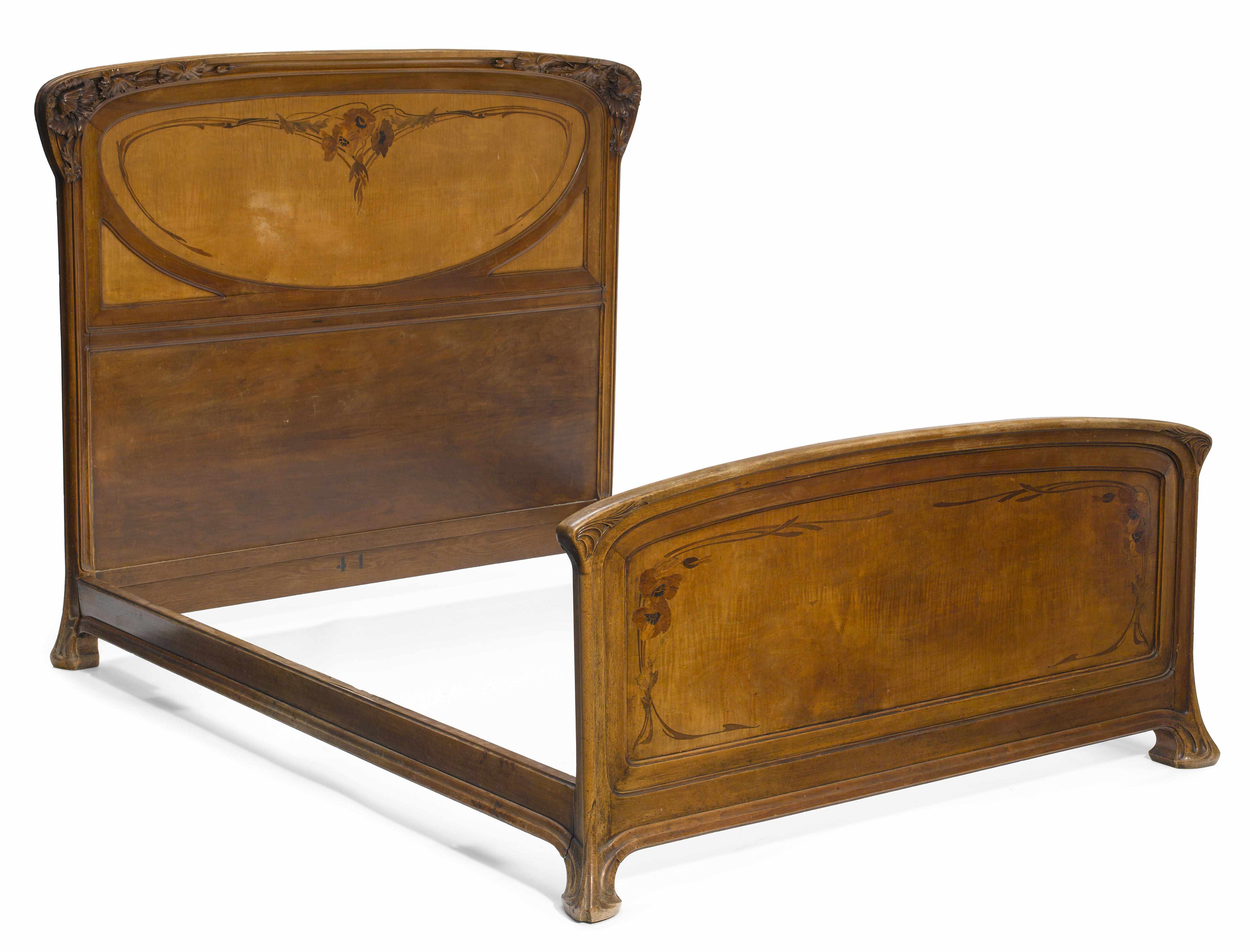 Appraisal: A French Art Nouveau marquetry and carved mahogany bedstead circa