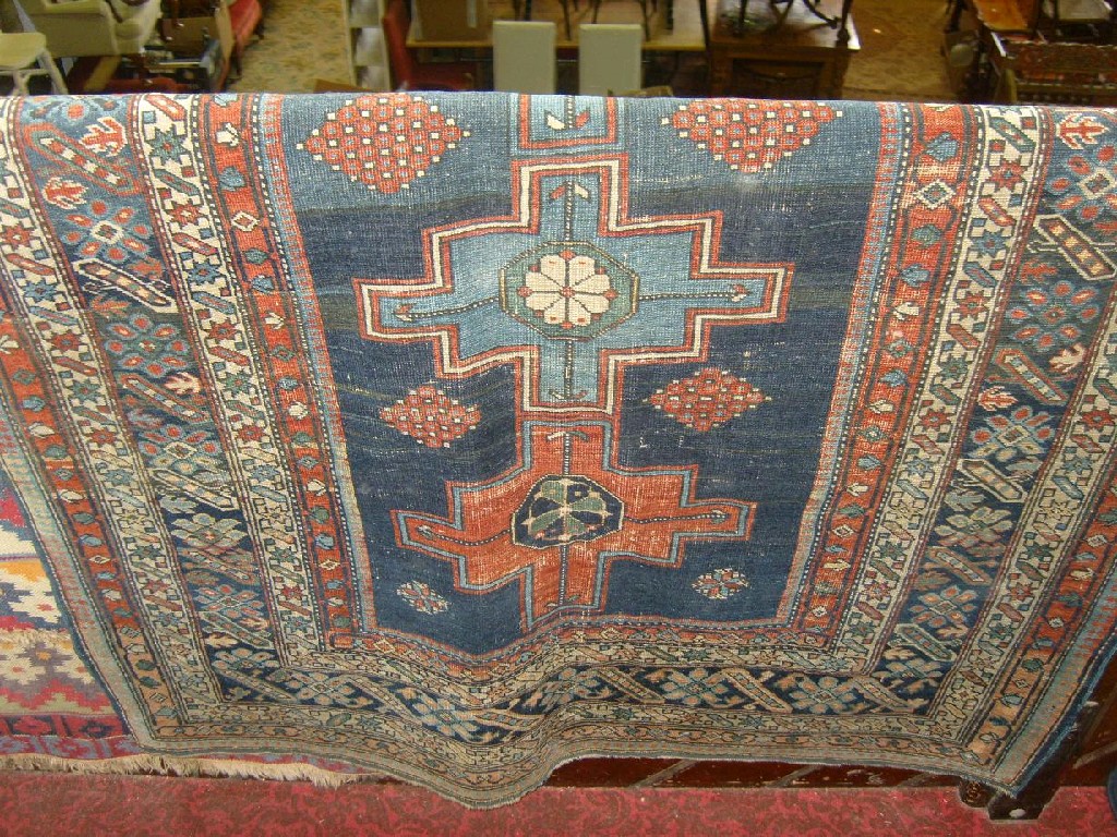 Appraisal: A Persian rug with geometric medallion centre upon a blue