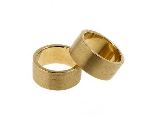 Appraisal: PAIR OF GOLD PARTNER RINGS Yellow gold g Attractive broad