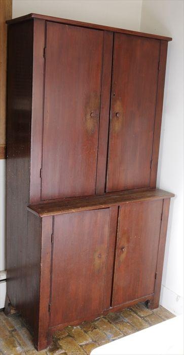 Appraisal: RED-STAINED STEP-BACK CUPBOARD The upper and lower sections each with