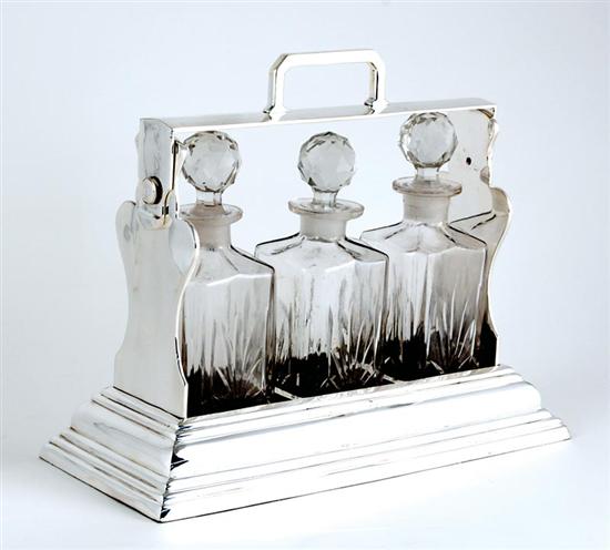 Appraisal: Silverplate three-decanter tantalus hinged top with handle supported by urn-shaped