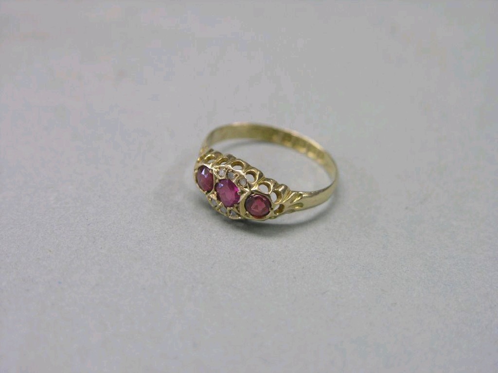 Appraisal: An ct gold ring set three red stones and tiny